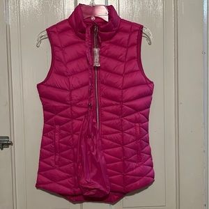 Tangerine puffy vest w/ removable carrying pouch . Zipper pockets size small
